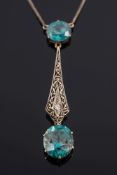 An early 20th century blue zircon and diamond mounted lavalier:,