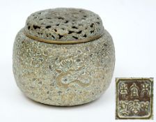 A Chinese polished bronze incense burner and cover: of globular form with pierced cover,