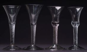 Four air twist wine glasses: two with bell shaped bowl,