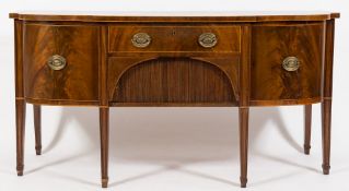 An early 19th Century mahogany and inlaid sideboard:, of bowed breakfront outline,