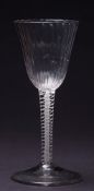 An opaque twist wine glass: the rounded funnel shaped bowl with vertical ribs on a mildly tapering