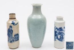 A group of three small Chinese vases: comprising a 'soft paste' blue and white sleeve vase painted