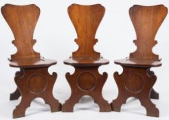 A set of eight mid 18th Century mahogany hall chairs:,