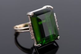 A green tourmaline single-stone ring:, the rectangular tourmaline approximately 20mm x 16mm,