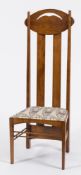An Art Nouveau oak high back chair in the manner of Charles Rennie Mackintosh:,