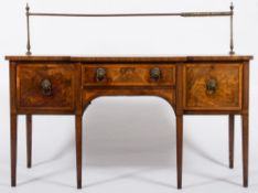 An early 19th Century mahogany, banded and inlaid rectangular breakfront sideboard:,