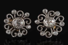 A pair of white metal and diamond circular,