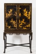 An early 19th Century Chinese black lacquer and gilt heightened cabinet on stand:,