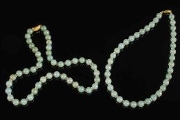 A jade bead single string necklace:, the beads separated between smaller glass beads,
