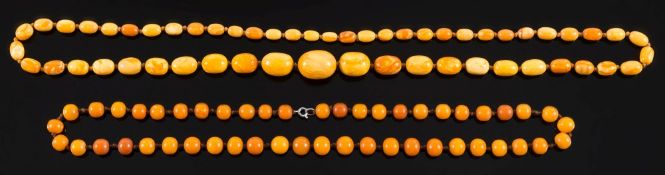 A graduated amber bead single string necklace: comprising 55 graduated oblong beads, 56.