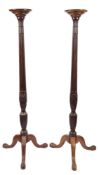 A pair of carved mahogany torchere stands:, in the Hepplewhite taste,