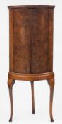 A mid 18th Century yew-wood bow-fronted hanging corner cupboard:,