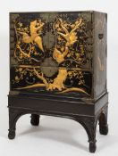 A 19th Century Japanese black and gold lacquer and engraved brass mounted cabinet on stand:,
