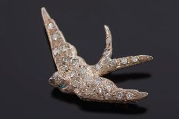 A diamond mounted swooping swallow brooch:.