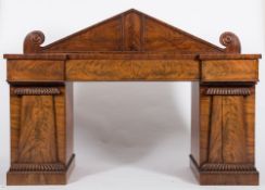 An early Victorian mahogany pedestal sideboard:, of recessed breakfront outline,