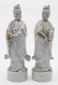 A pair of Chinese blanc de Chine figures of Guanyin: one holding a ruyi sceptre, the other a child,