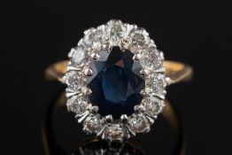 An 18ct gold, sapphire and diamond oval cluster ring:,