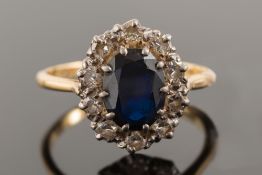 An 18ct gold, sapphire and diamond oval cluster ring:,