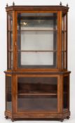 A 19th Century mahogany display cabinet:, of canted design, in two sections,