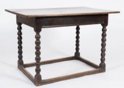 A 17th Century oak rectangular side table:, with an overhanging top and moulded frieze,