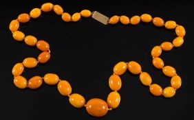 A graduated amber bead single-string necklace: comprising 40 graduated, oblong beads,