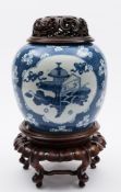 A Chinese blue and white ginger jar: painted with auspicious objects within three lobed panels on a