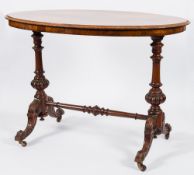 A Victorian carved walnut oval centre table:, the burr quarter veneered top with a moulded edge,