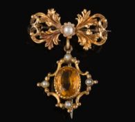 A citrine and cultured seed-pearl bow brooch: with drop and stamped '750'.