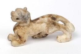 A Chinese carved jade figure of a Buddhist lion: the stone of mottled grey and brown colour, 6.