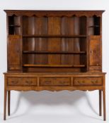 An early 19th Century oak and crossbanded dresser:,
