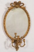 A 19th Century giltwood and gesso oval girandole mirror:,