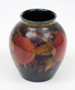 A Moorcroft pottery vase: of oviform tubelined in the Pomegranate pattern in red, orange,