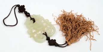 A Chinese carved jade pendant:, of pale celadon colour, with pierced and scroll decoration,