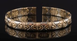 A two-colour bangle: of contemporary design stamped '585', approximately 40gms gross weight.