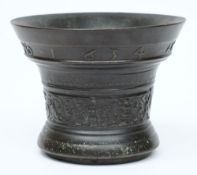 A 17th century Dutch dated bronze mortar:, of circular flared form,