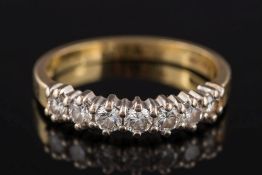 An 18ct gold and diamond seven-stone half-eternity ring: with circular brilliant-cut diamonds,