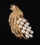 A freshwater cultured pearl mounted spray brooch: stamped 14K'.
