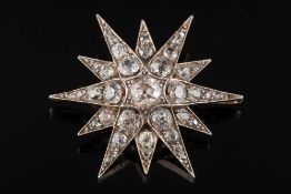 A late 19th century gold, silver and diamond mounted 12-point star pendant/brooch: with graduated,