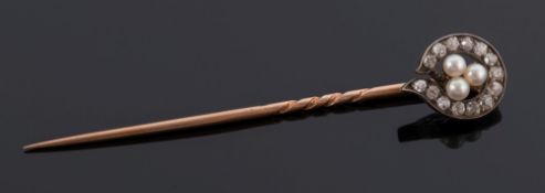 A diamond and seed-peal set stick-pin: with central trefoil cluster of seed-pearls within a