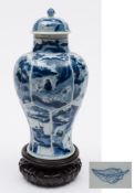 A Chinese blue and white baluster vase and cover: moulded with lotus panels and painted overall