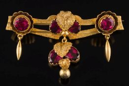 Three red paste-set drop fittings subsequently attached to a bar brooch stamped '18ct':,