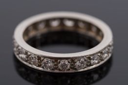 A diamond mounted eternity ring:, pave-set with 19 circular,