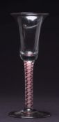 A Dutch colour twist wine glass: the bell shaped bowl on a straight stem containing a central white