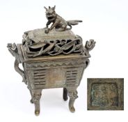 A Chinese bronze incense burner and cover:  of archaic form with buddhistic lion finial and cast