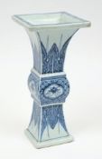 A Chinese blue and white vase: of archaic 'Gu' form, painted with auspicious objects,