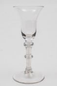 An opaque twist wine glass: the bell shaped bowl set on a straight stem with two annular knops