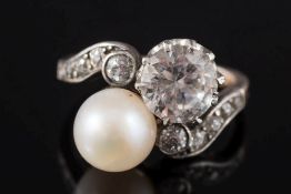 A diamond, pearl or cultured pearl and gem-set cross over ring: with diamond-set shoulder,