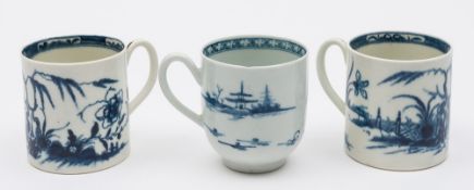 A pair of Worcester First Period porcelain coffee cans and a cup: the former painted in blue in the