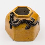 A Chinese yellow-ground octagonal water pot: the neck applied with a black-glazed chilong,