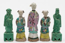 A group of three Chinese famille rose figures of Immortals: wearing floral decorated green and pink